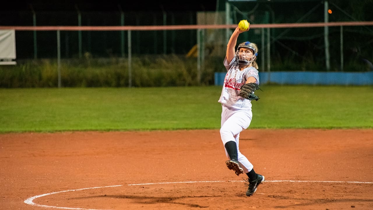 Softball Players Pitch Underhand Softball Players Pitch Underhand