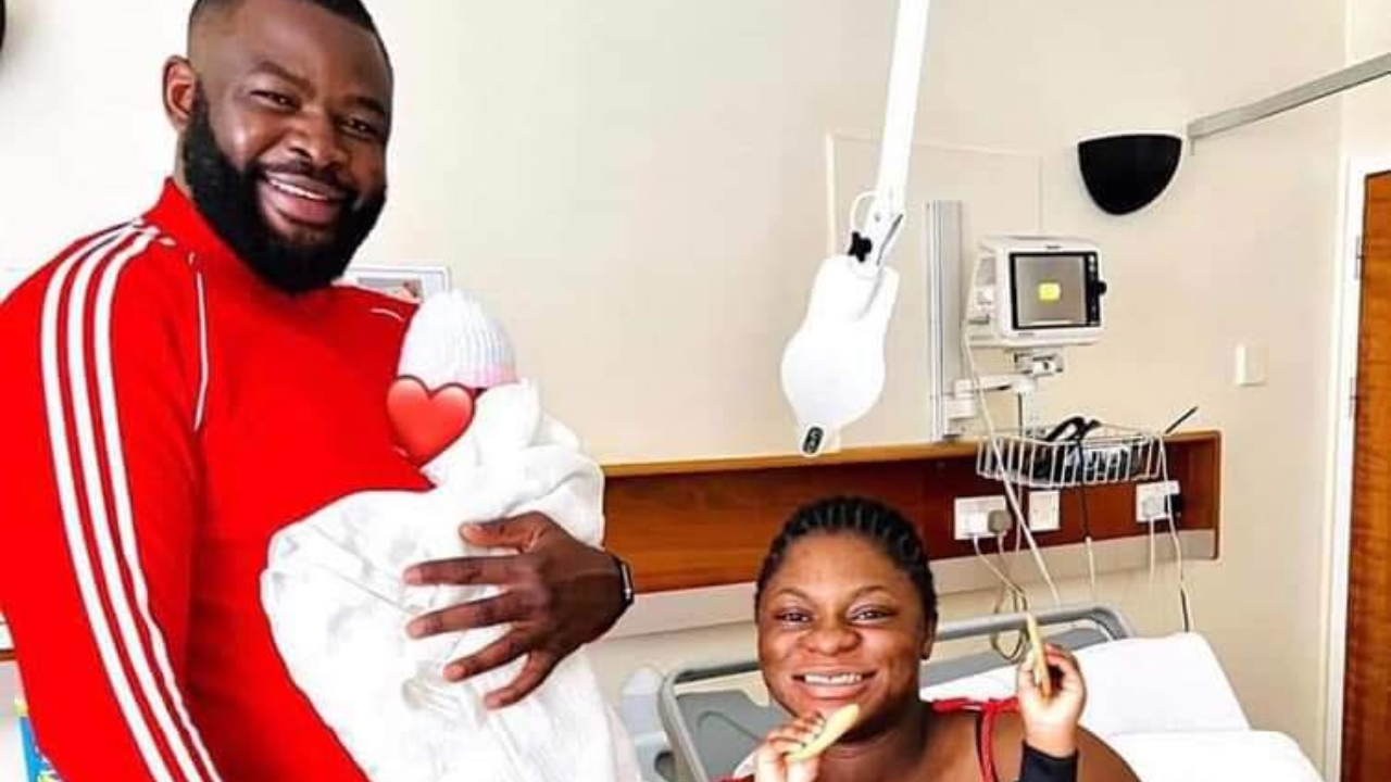 Martin Bakole with his wife and child