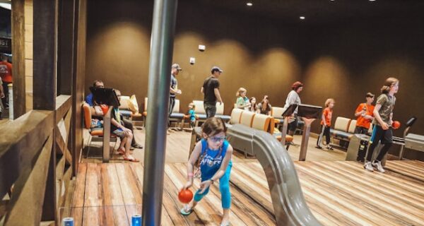 a group of children playing basketball on a wooden floor