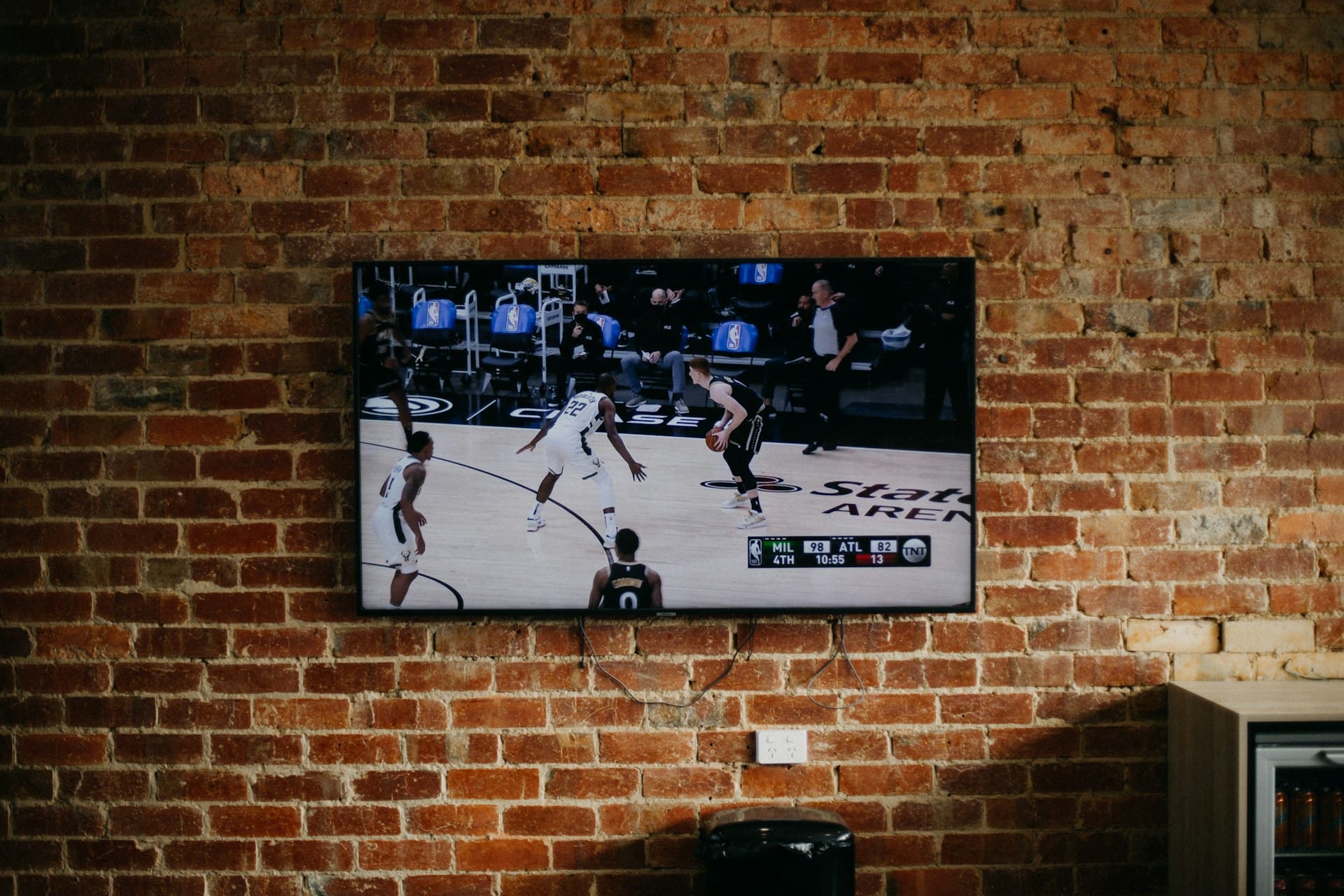 black flat screen tv mounted on brown brick wall black flat screen tv mounted on brown brick wall