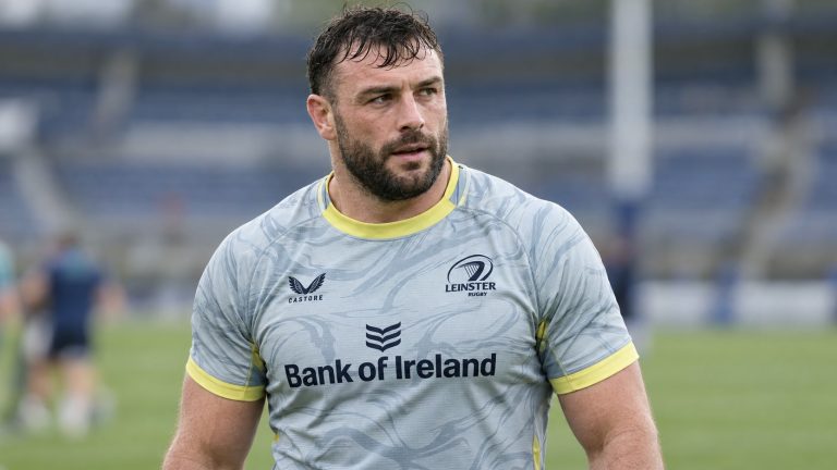 Jack Conan wearing Leinster’s light gray jersey with yellow trim on a rugby field.
