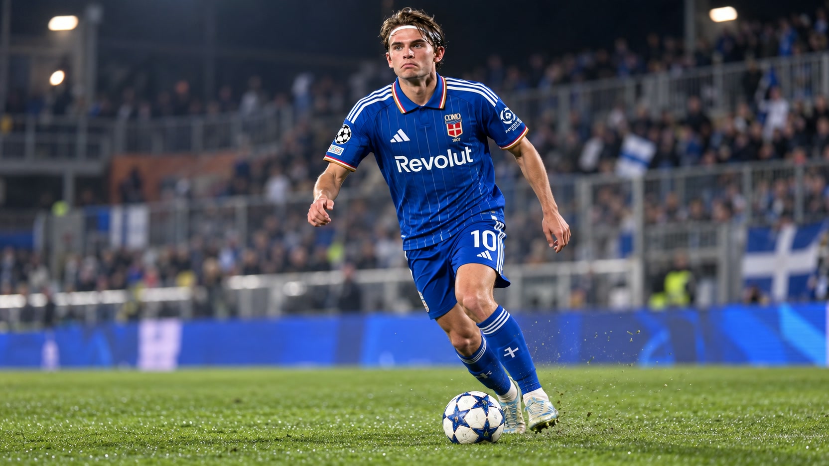 Nico Paz in Como’s blue home kit Nico Paz in Como’s blue No. 10 kit controlling a football on a floodlit pitch.
