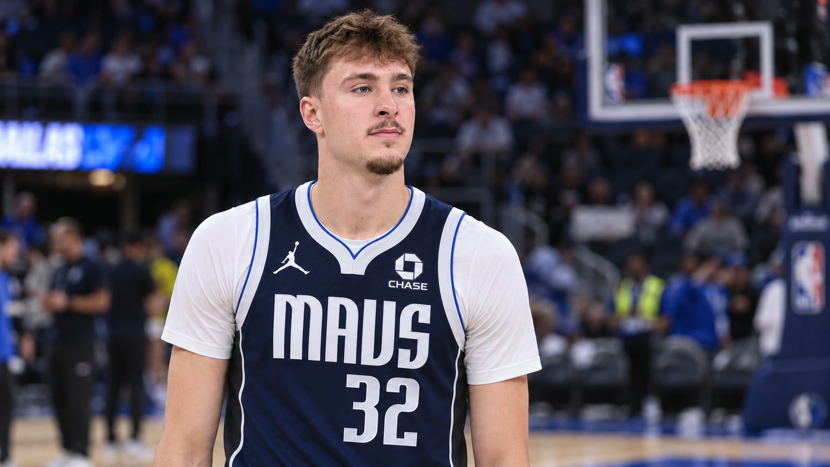 Cooper Flagg wearing a navy MAVS number 32 Statement jersey with a white undershirt in a basketball arena.