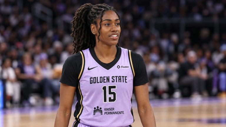 Tiffany Hayes wearing a lavender Golden State number 15 jersey over a black undershirt on a basketball court.
