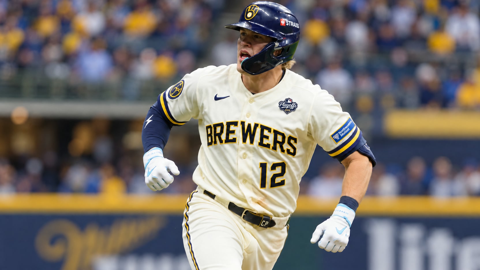 Cooper Pratt in Milwaukee Brewers home uniform Cooper Pratt running in a cream Milwaukee Brewers No. 12 jersey, navy helmet and white batting gloves.