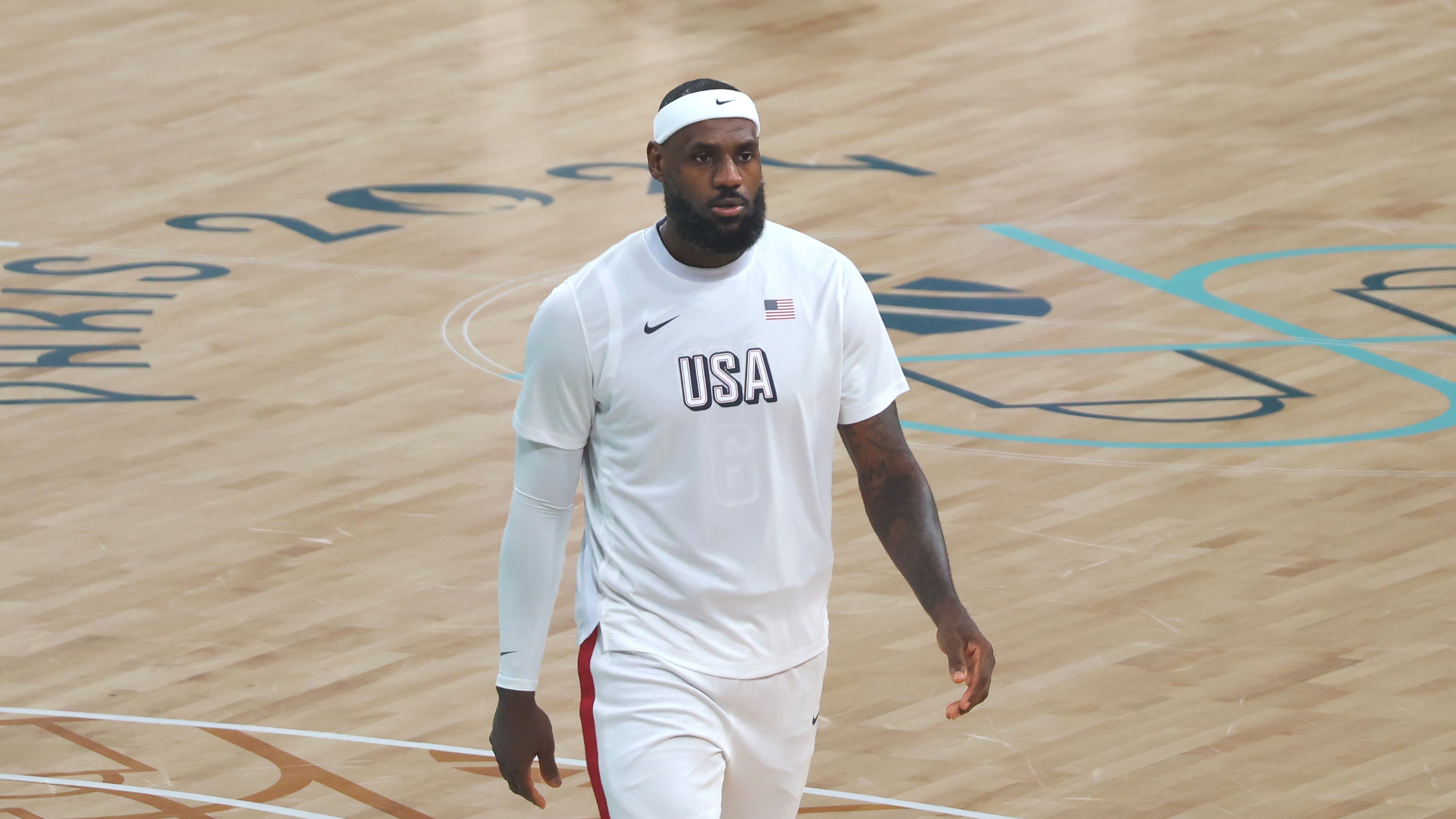 LeBron James at the Paris Olympics, August 3, 2024 — Clément Bardot, CC BY-SA 4.0, cropped LeBron James wearing white USA warmup clothing and a white headband at the Paris Olympics on August 3, 2024.