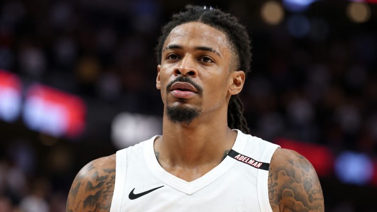 Ja Morant wearing a white Portland Trail Blazers jersey with a black Nike swoosh and Adelman shoulder patch.